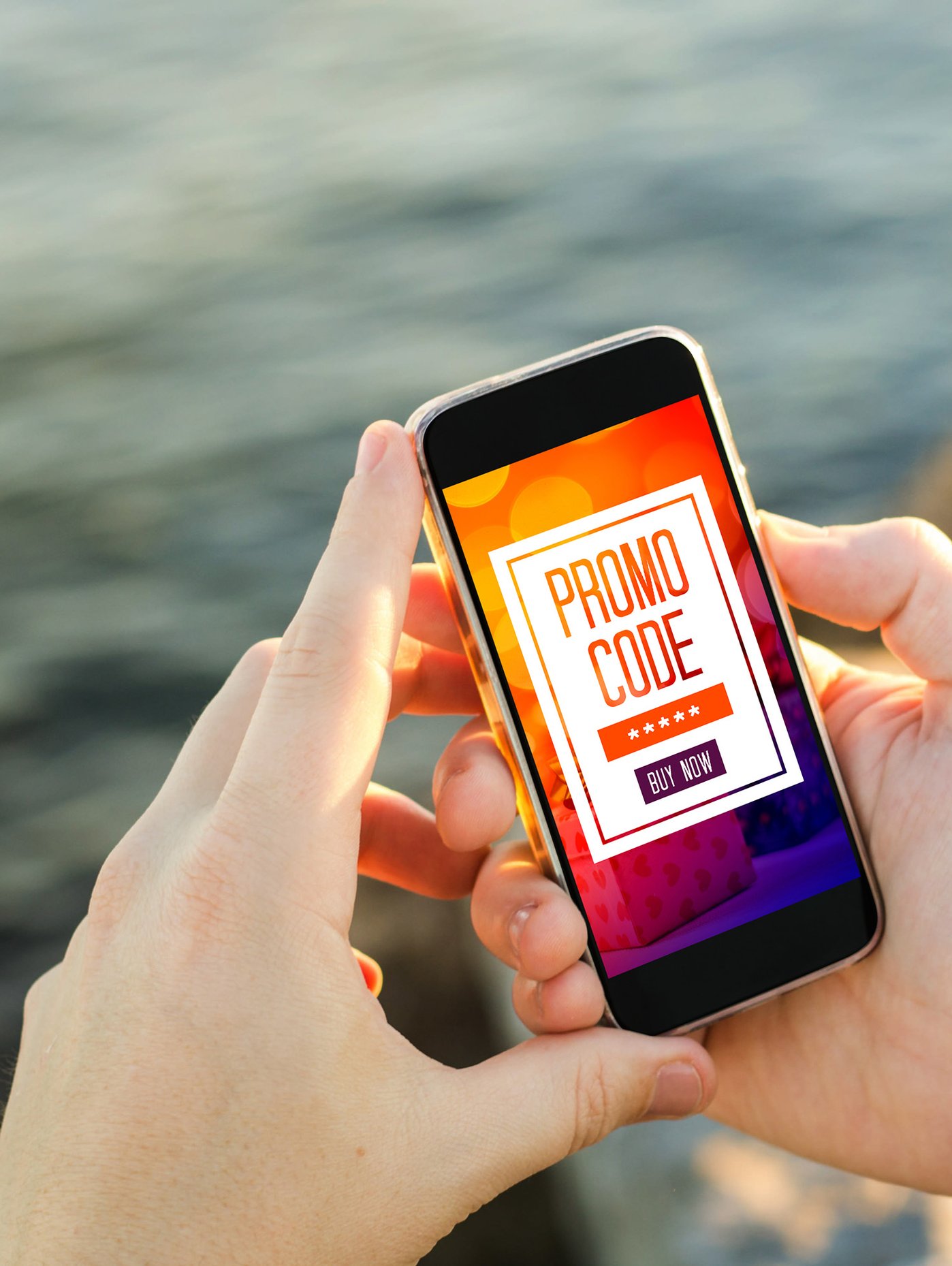 Image of person holding mobile device with discout offer on screen